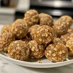 ['Close-up view of No Bake Pumpkin Spice Energy Bites with a textured surface.', 'Side view of several No Bake Pumpkin Spice Energy Bites arranged on a plate.', 'A cluster of No Bake Pumpkin Spice Energy Bites with visible chocolate chips and oats.', 'Juicy No Bake Pumpkin Spice Energy Bites highlighting ingredients like pumpkin puree and chia seeds.']