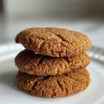 Close-up view of golden brown ginger cookies made with almond flour, showing a crispy exterior.