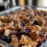 Close-up view of a Healthy Blueberry French Toast Casserole with blueberries on top.