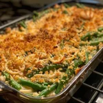 A close-up view of a healthy green bean casserole with a creamy texture and crunchy topping.