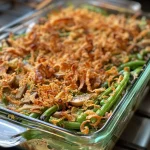 Close-up view of a delicious vegan green bean casserole topped with crispy onions.